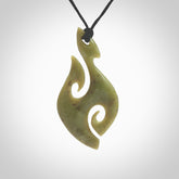 This photo shows a koru pendant carved from New Zealand Jade. The artist, Shaun Gardiner, has carved this beautifully. We provide this piece with an adjustable black cord. This is a fantastic work of art, we have one only.